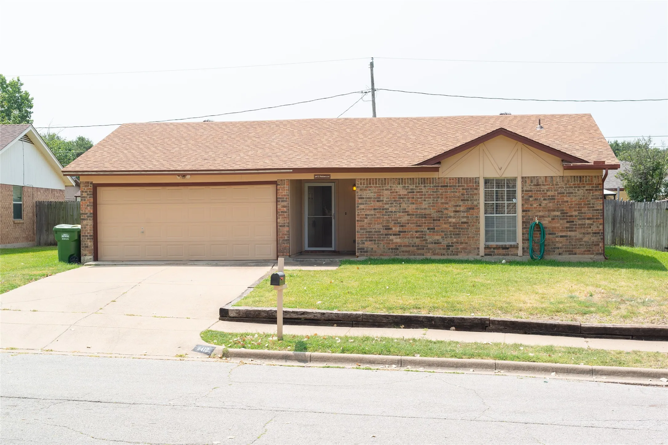 Brick and siding exterior with a single-car garage and concrete driveway