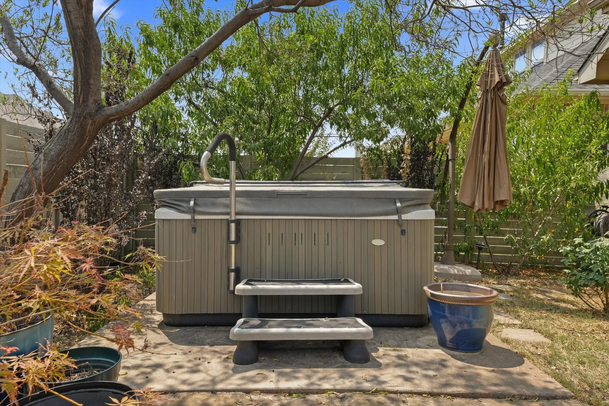 Private hot tub nestled among mature landscaping, creating a peaceful outdoor retreat to relax and unwind at the end of the day.