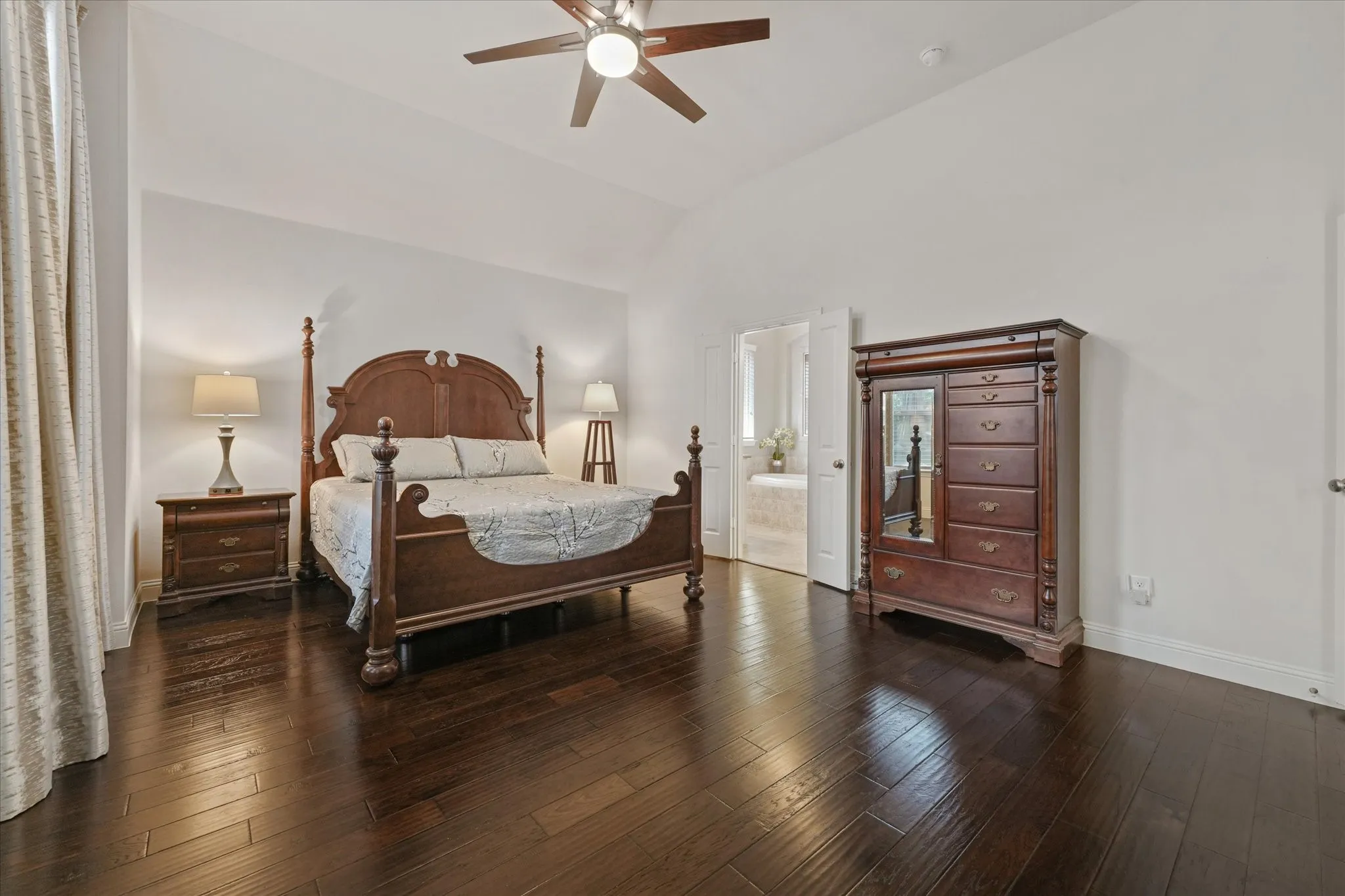 Private primary bedroom with generous floor space, vaulted ceiling and a spacious layout designed to accommodate large furniture.
