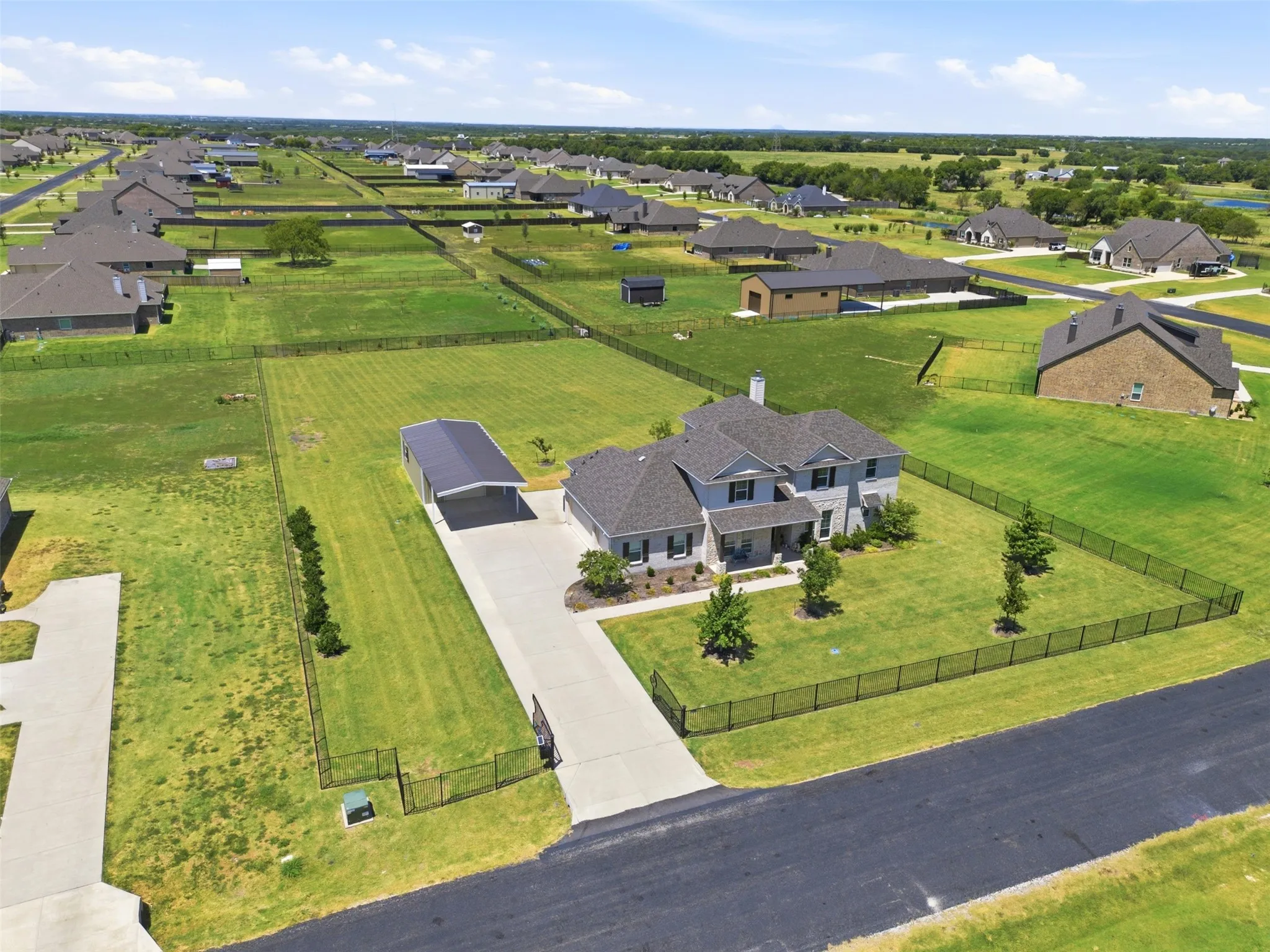 Stunning brick residence situated on expansive manicured grounds with mature landscaping and fencing