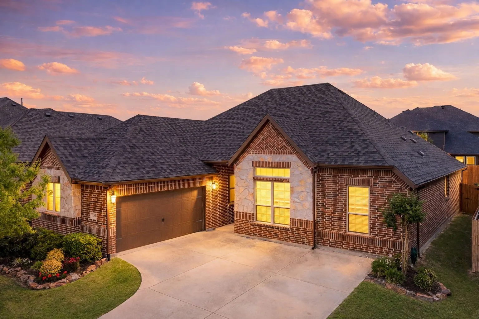 Stone enhanced elevation with spacious driveway and pretty flowerbeds.