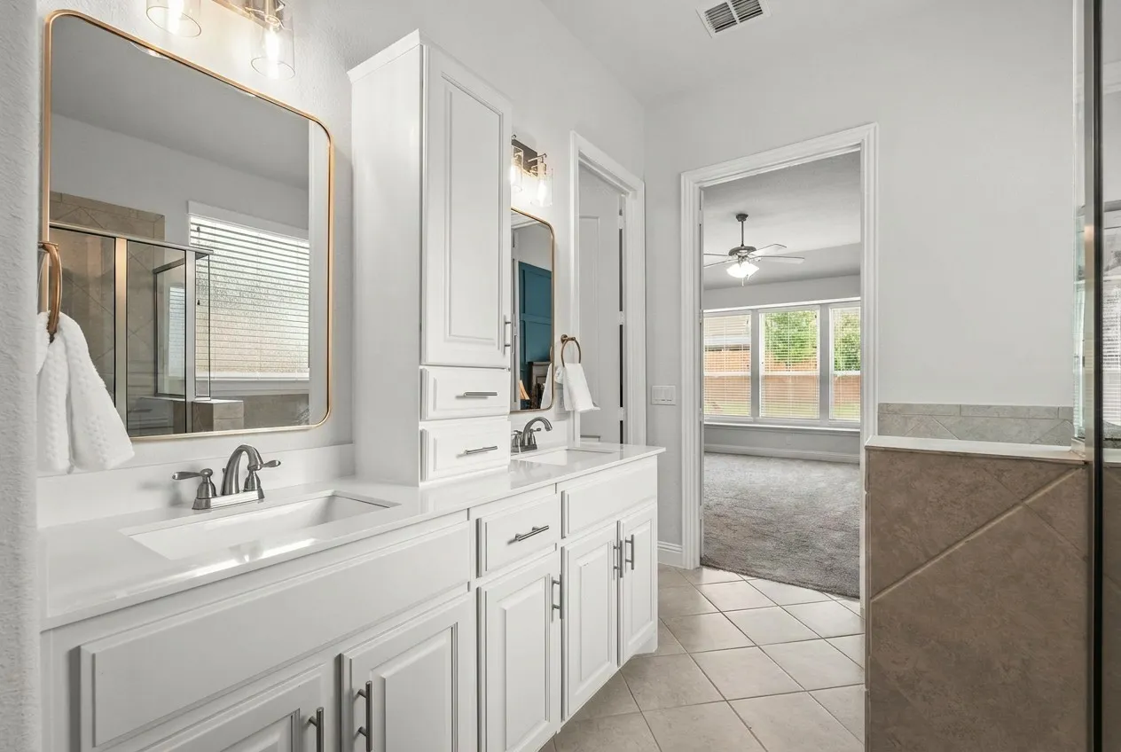 Primary Bath with quality built-in cabinets, separate shower, garden tub and large walk-in closet with built-in ironing table!