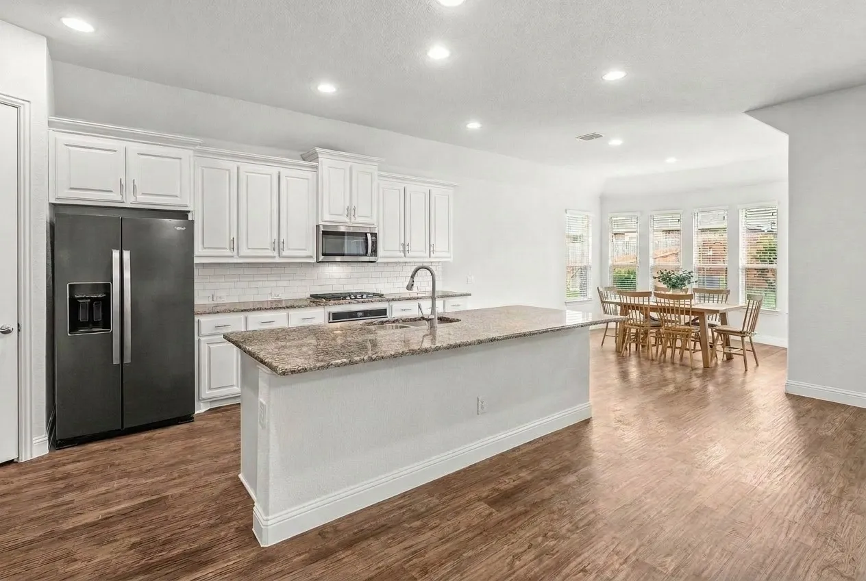 Stainless appliances and spacious island, great for entertaining. Views leading to the dining room with bay windows overlooking the peaceful backyard.