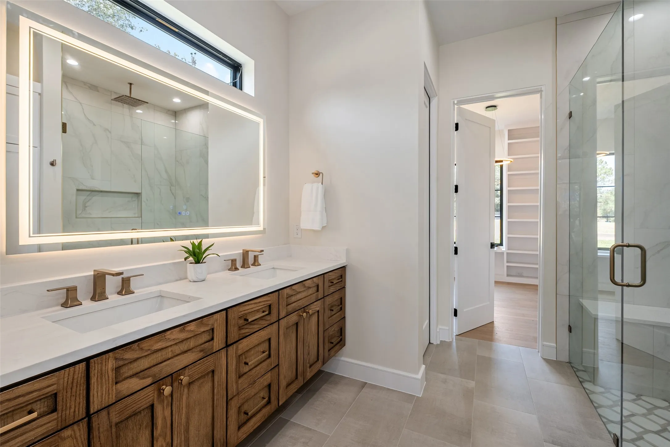 Dual vanity with undermount sinks and bronze-finish fixtures