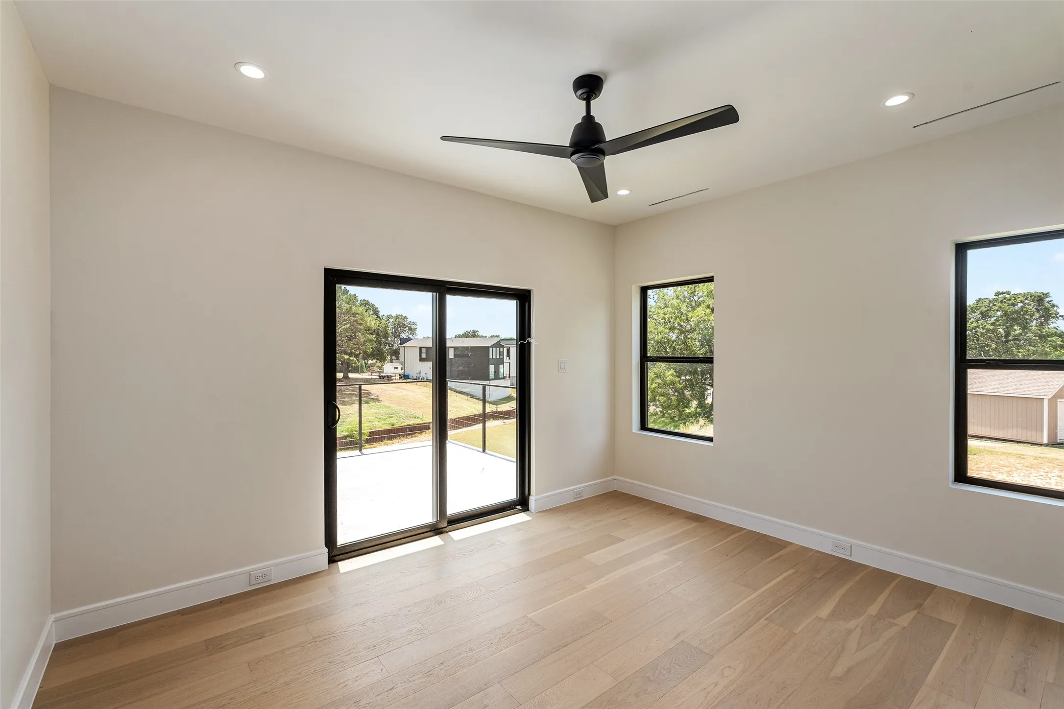 Light-toned wood-finish flooring complements the neutral wall color
