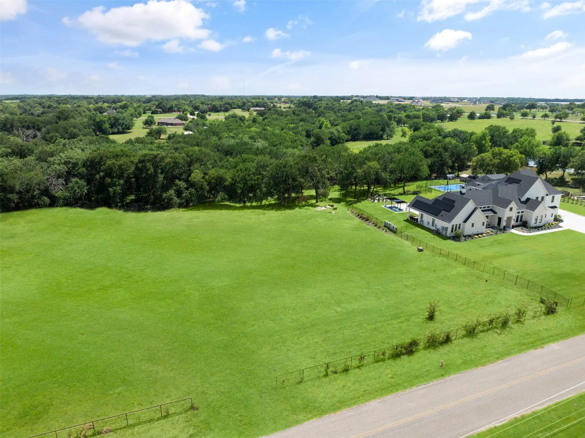 Aerial view of sparsely populated area featuring a tree filled landscape