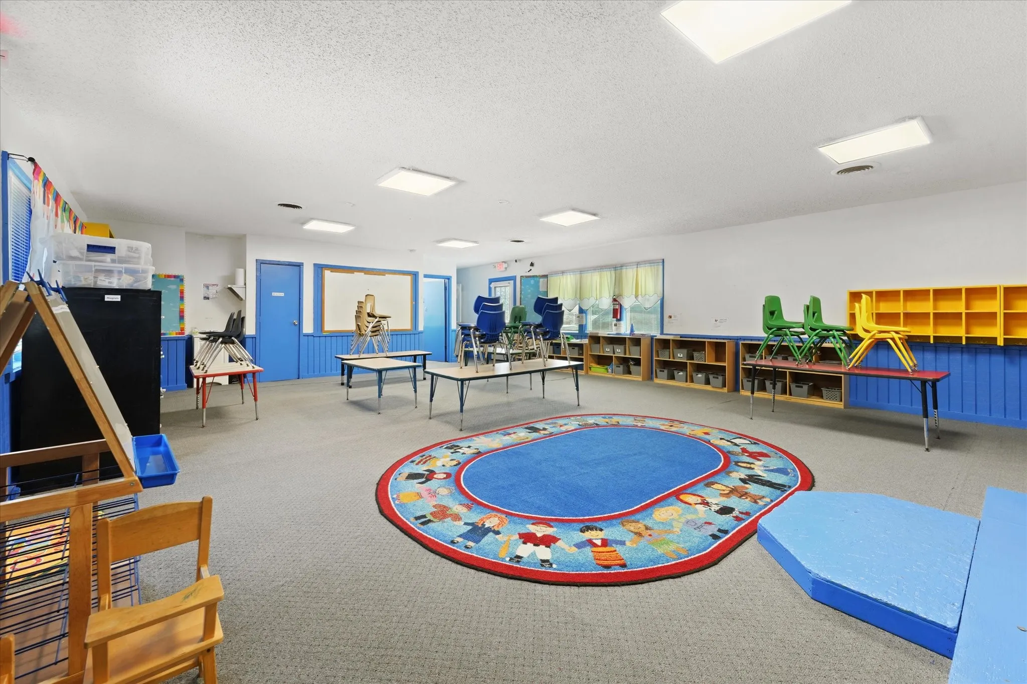 Spacious room featuring neutral carpet flooring and white walls