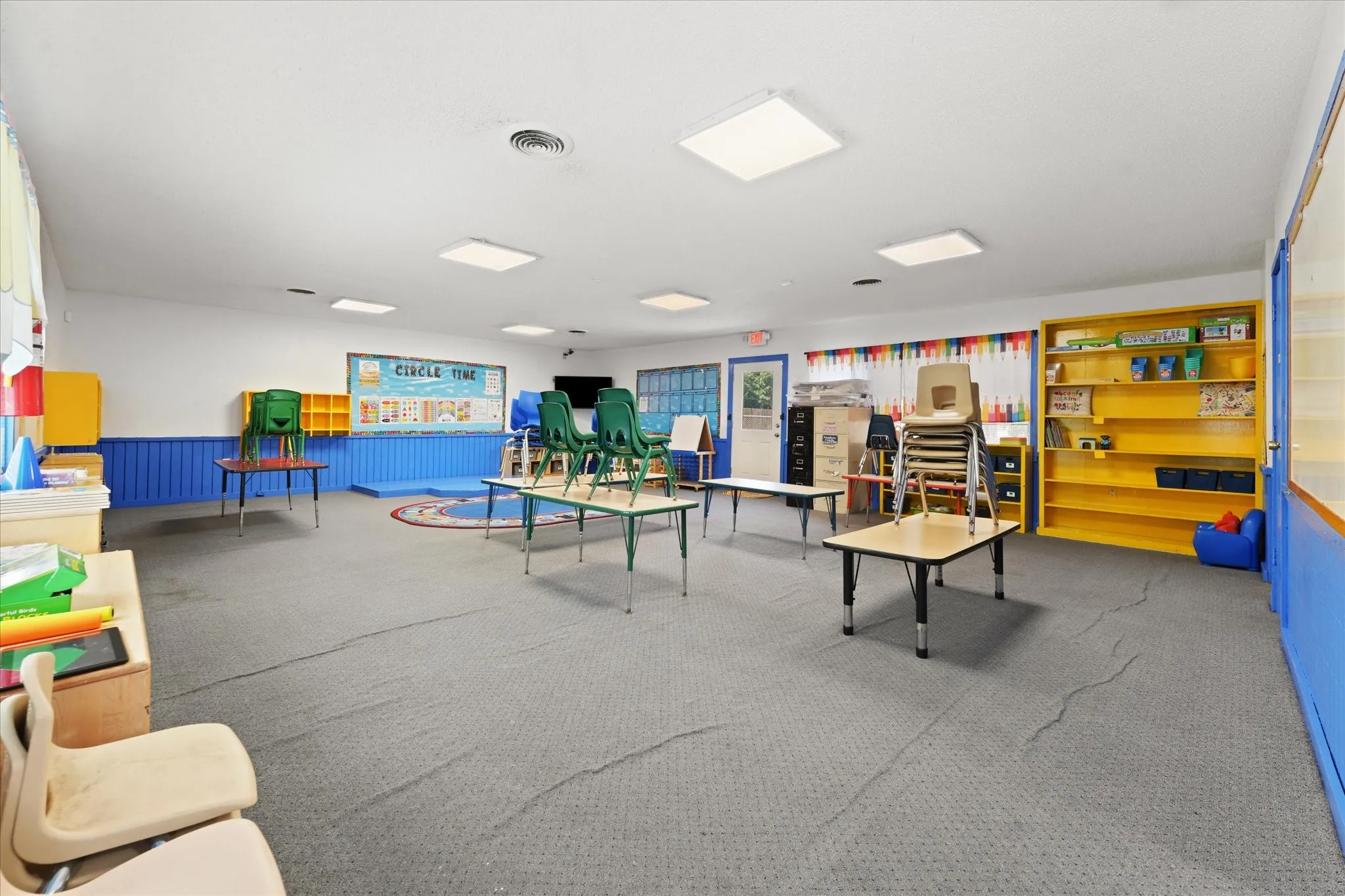 Spacious interior room with light gray patterned flooring
