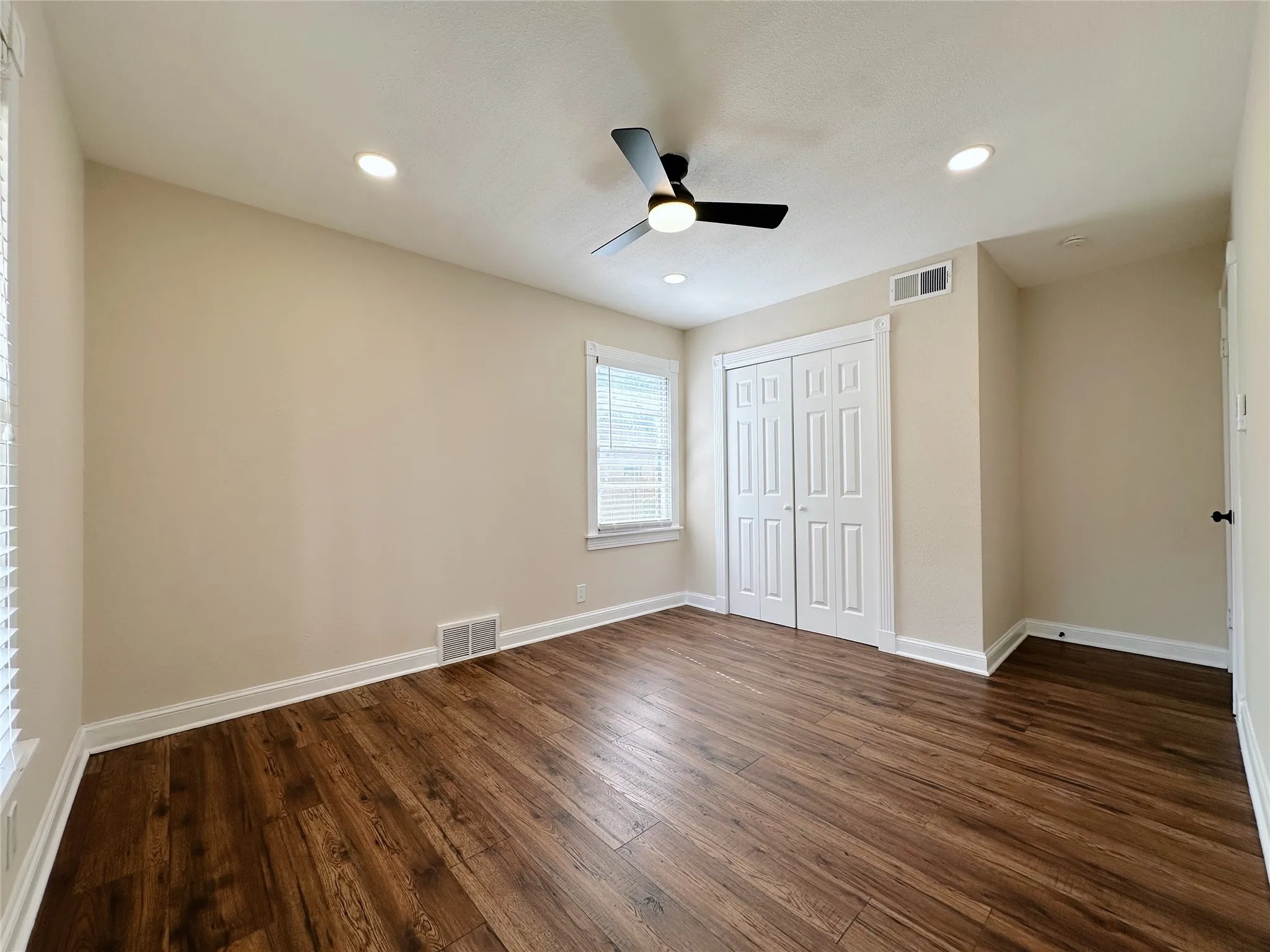 Wood-finish flooring, recessed lighting, and a modern ceiling fan