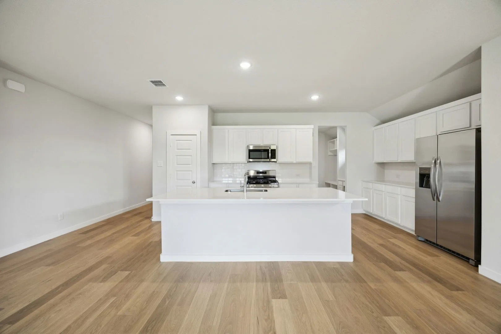 Kitchen in the Heisman home plan by Trophy Signature Homes – REPRESENTATIVE PHOTO