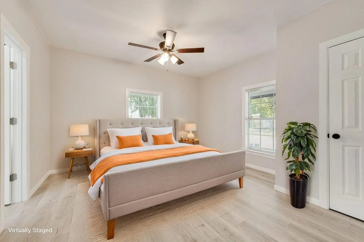 Virtually staged Light wood-finish flooring, white walls, and a ceiling fan with integrated lighting