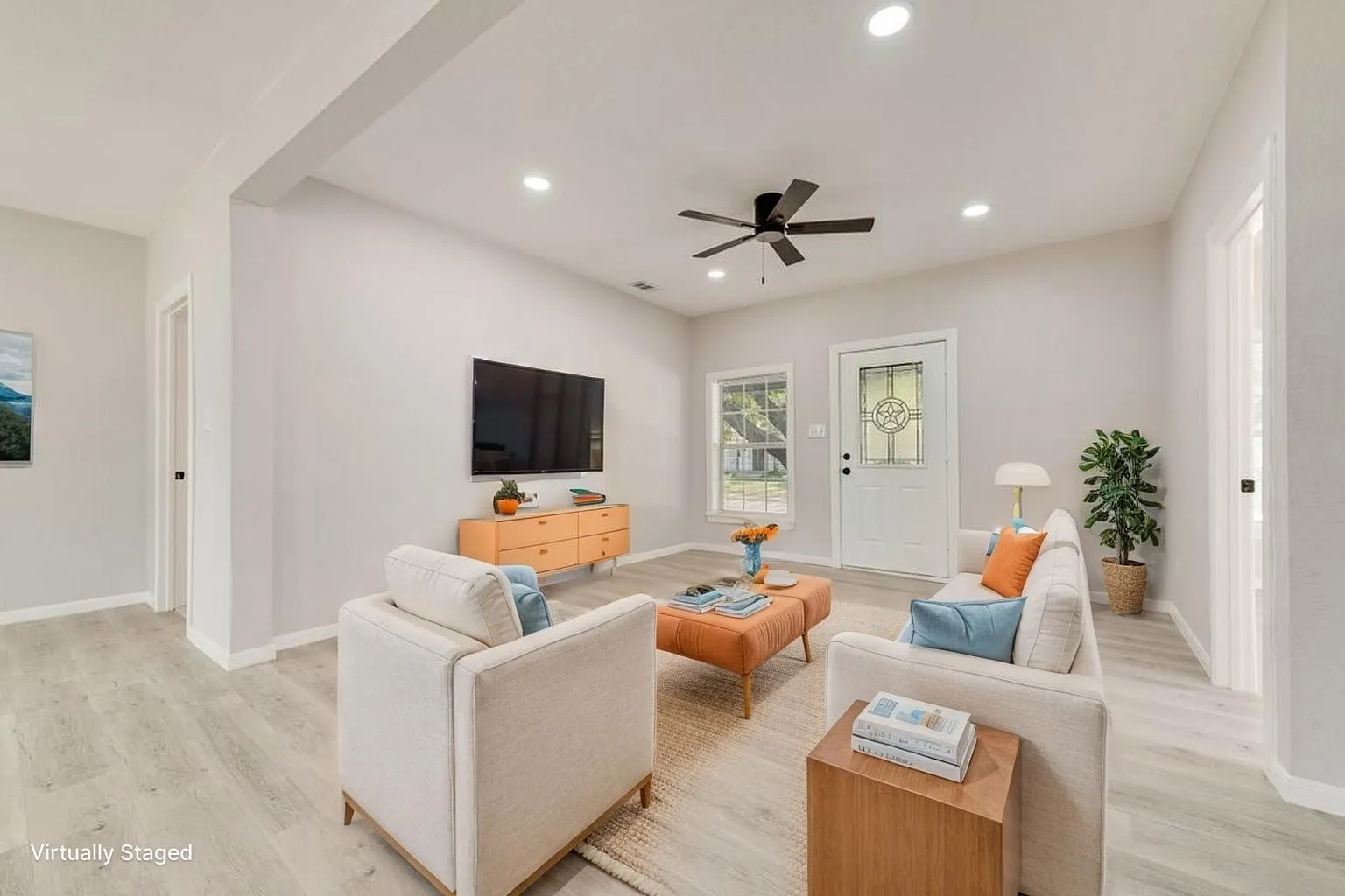 Virtually staged Open-concept living area featuring light wood-finish flooring, recessed ceiling lighting, and a ceiling fan