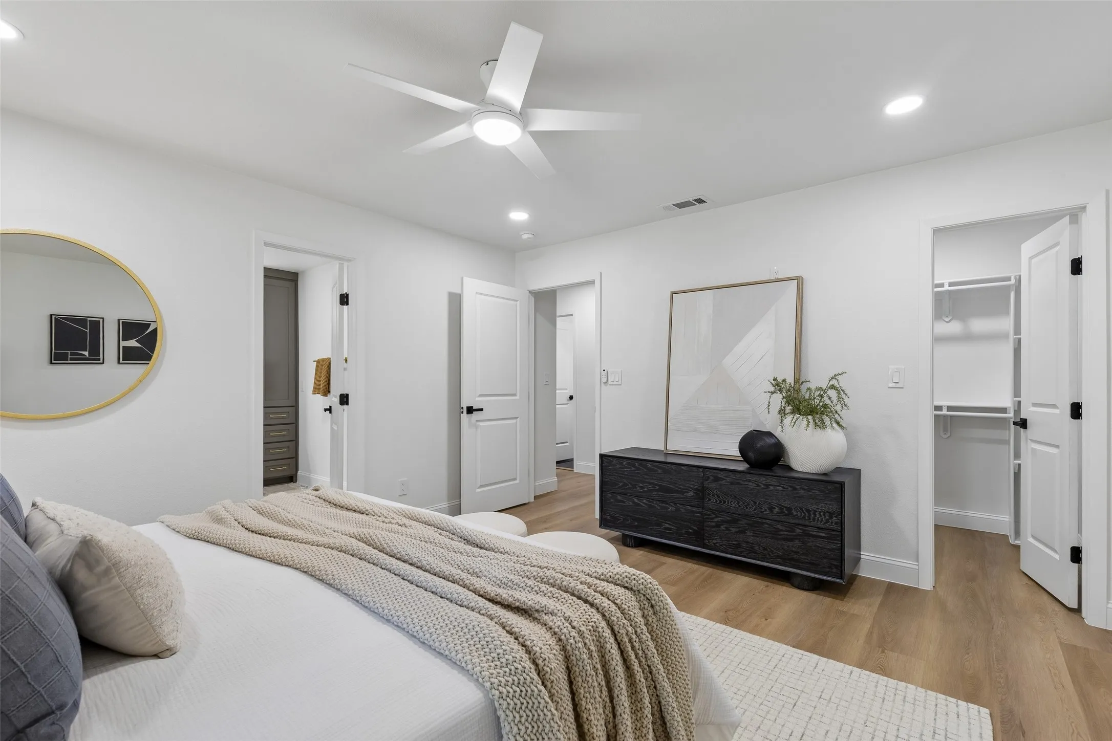 Wood-finish flooring, recessed lighting, and a ceiling fan