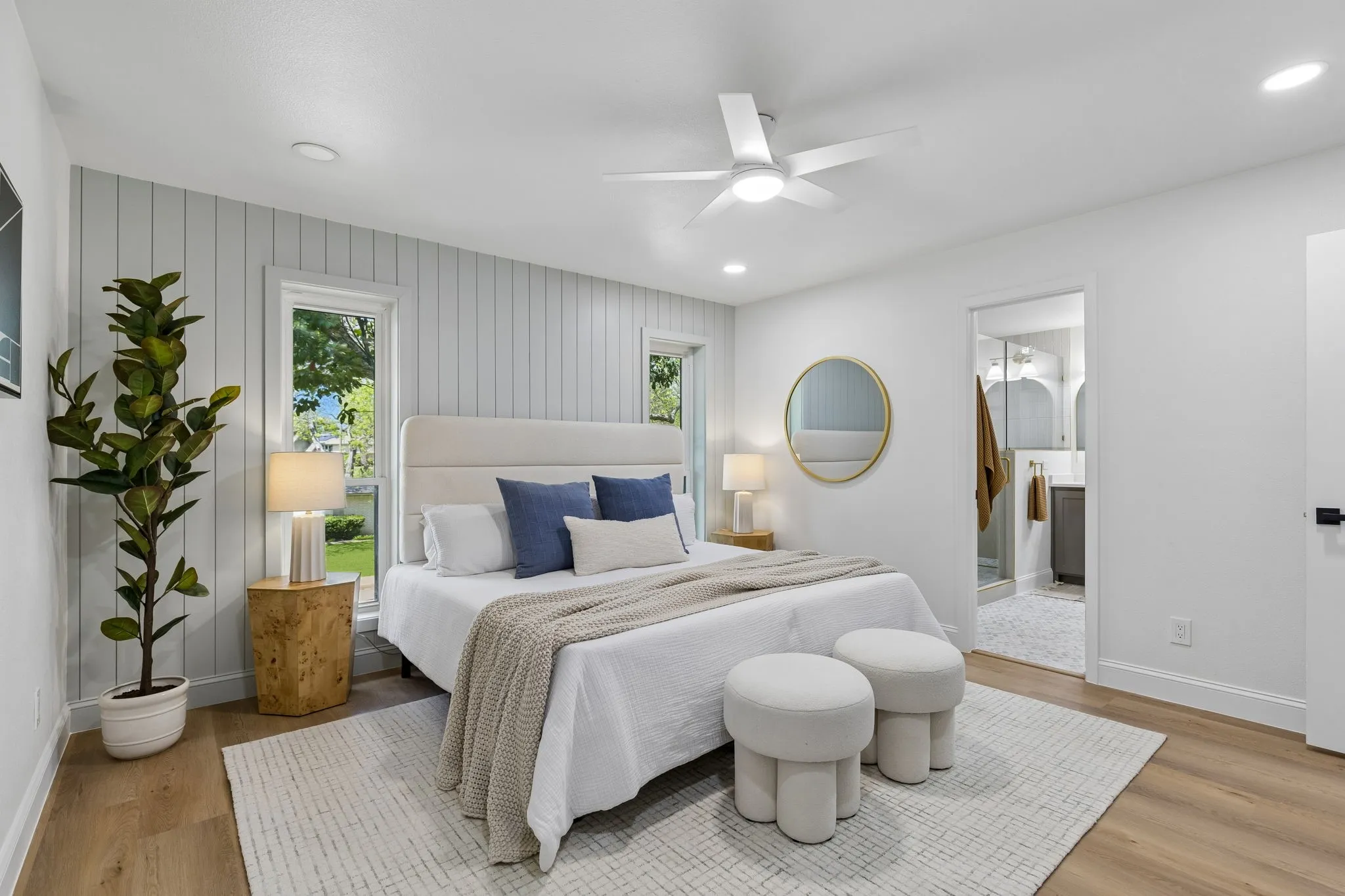 Wood-finish flooring, recessed lighting, and a ceiling fan are featured