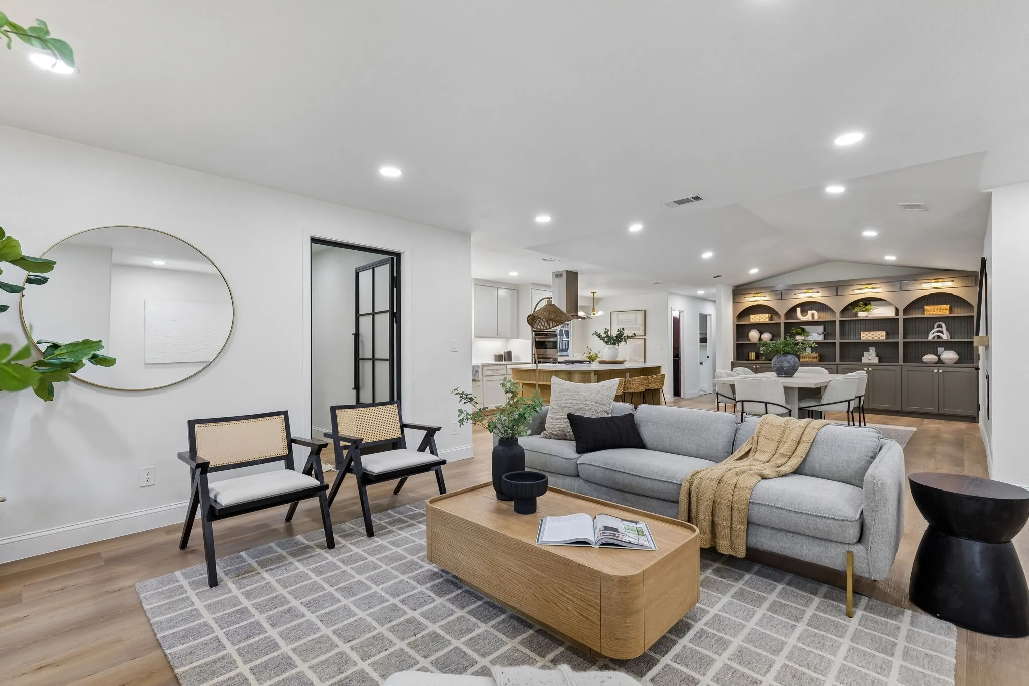Wood-finish flooring, recessed lighting, and a built-in shelving unit with integrated lighting