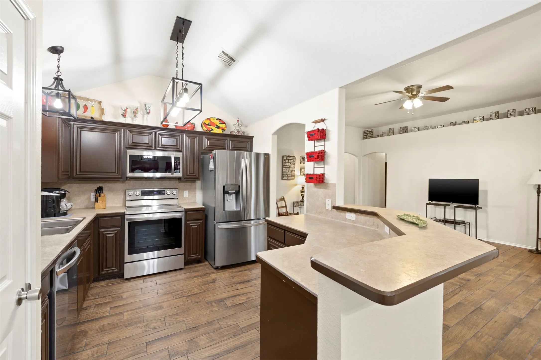 Open concept kitchen with new appliances, kitchen island with seating, and a nice open concept