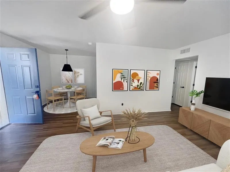 Living room featuring wood finished floors and a ceiling fan
