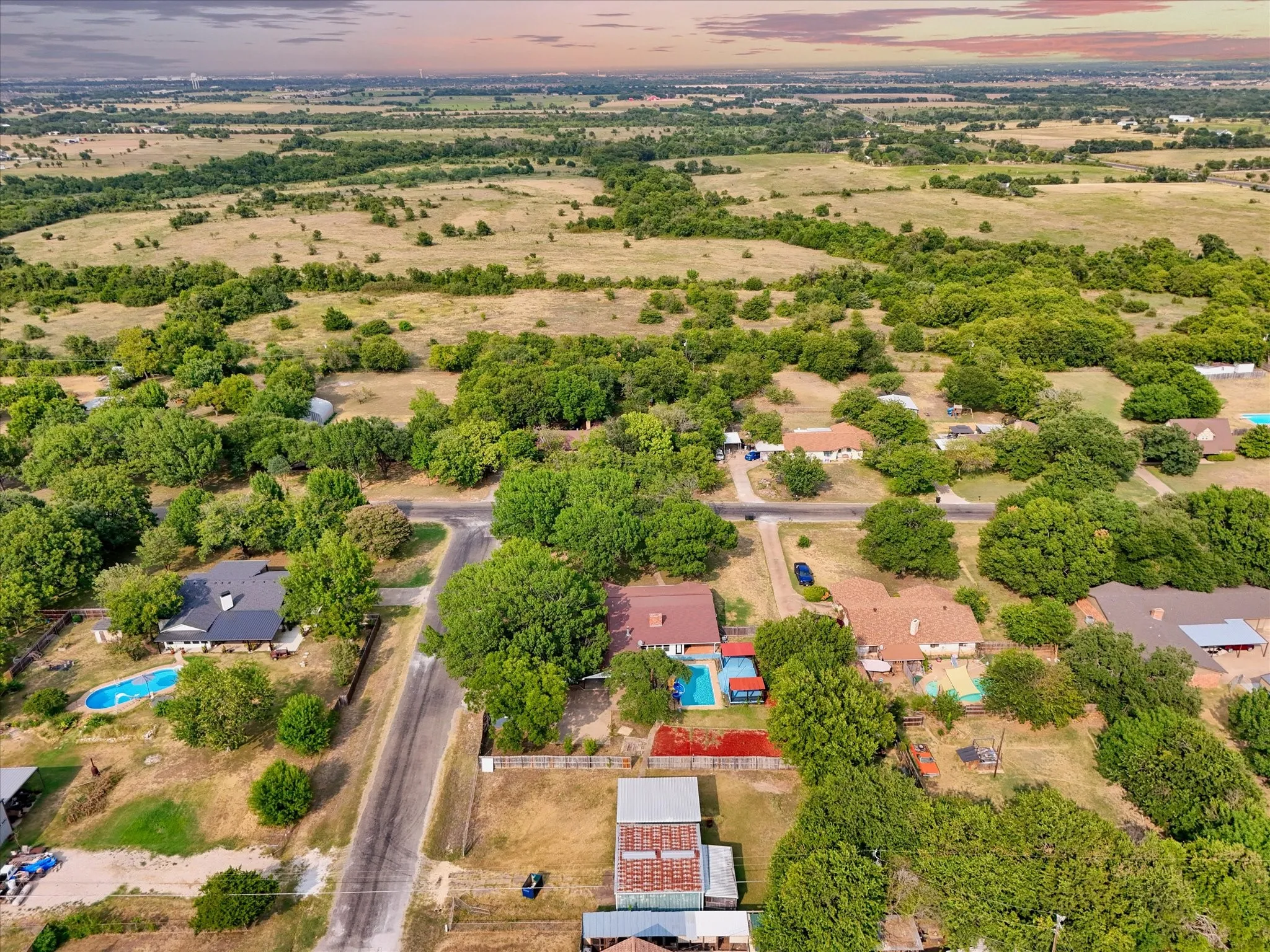 Expansive rural landscape with scattered homes and mature trees