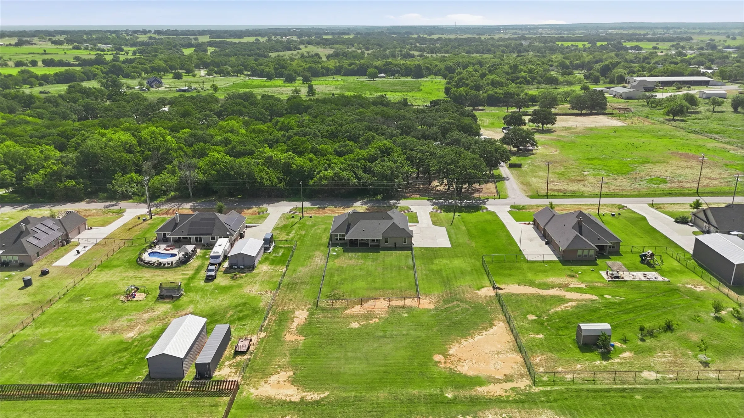 Expansive green acreage with mature trees