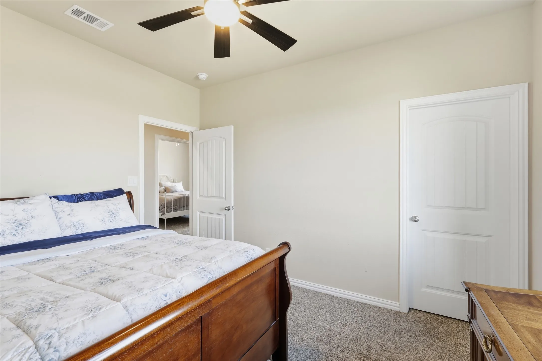Neutral wall color, ceiling fan with integrated lighting, recessed lighting, white interior doors, and carpet flooring