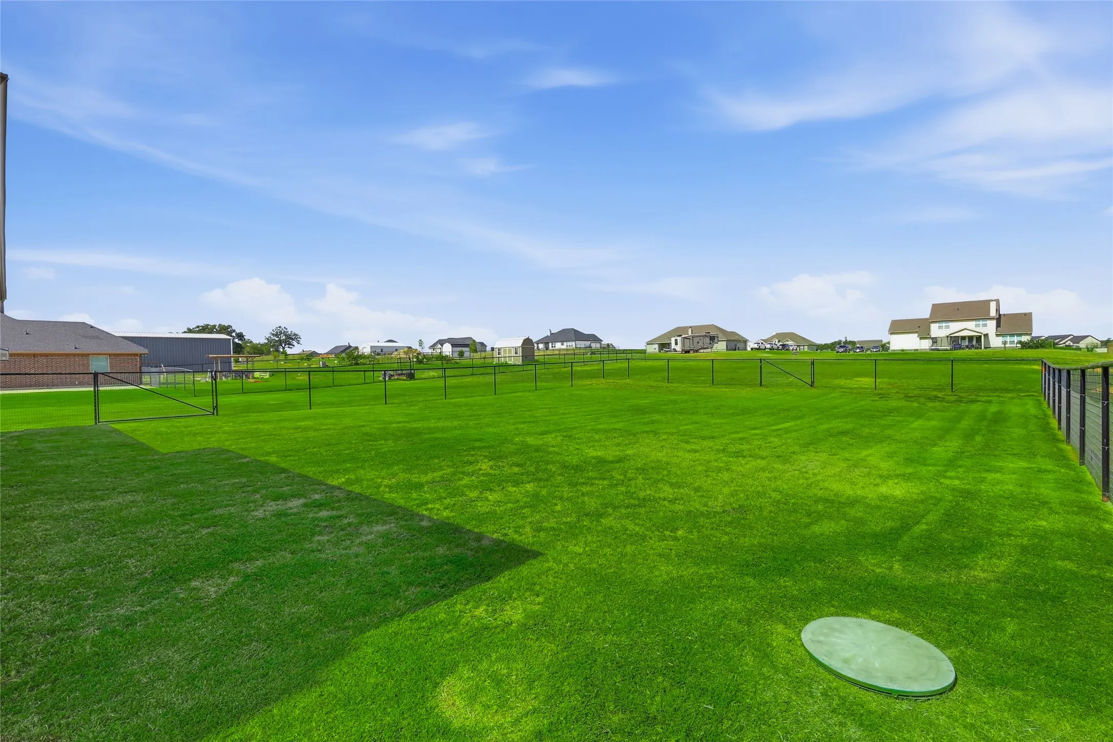 Expansive lawn area with a perimeter fence