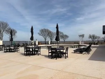 Expansive concrete patio with a built-in swimming pool