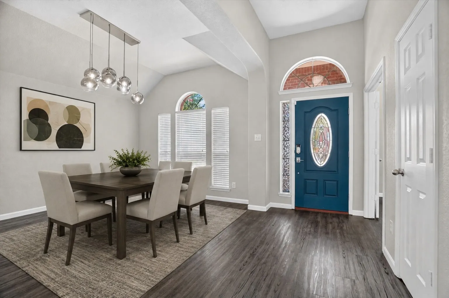 Virtually staged
Vaulted ceilings and dark wood-finish flooring complement the entrance and dining area