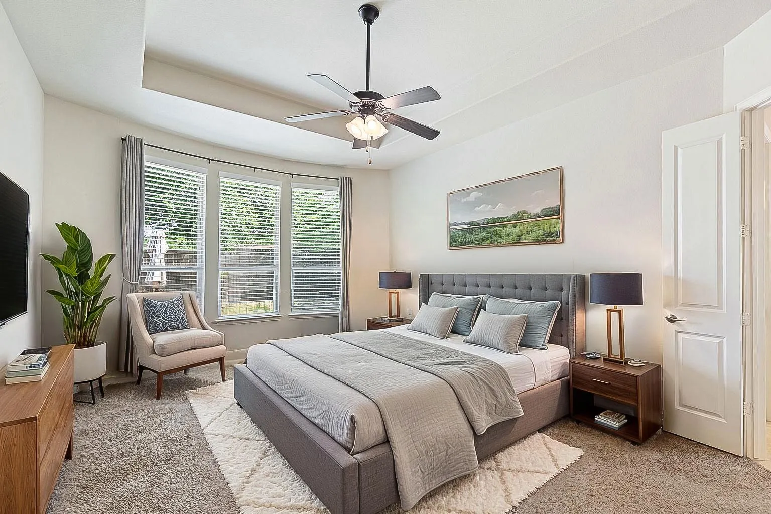 Primary bedroom, overlooking the pool and back yard, virtually staged