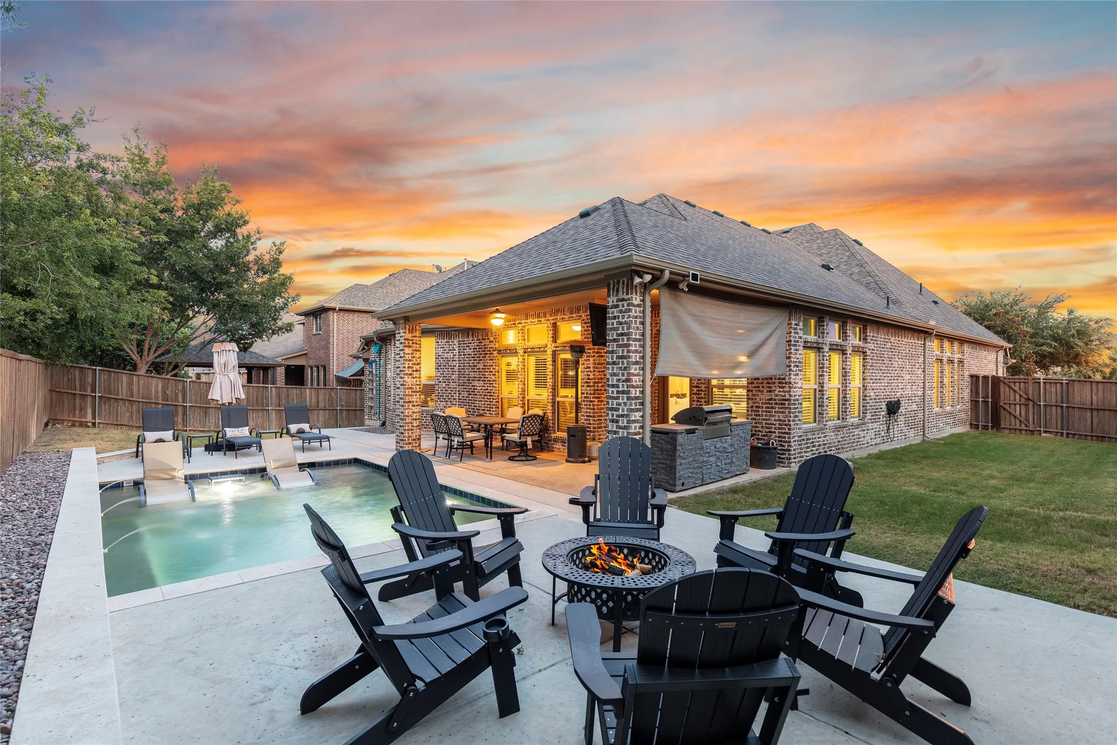 Outside view of pool, yard, sitting area and covered patio