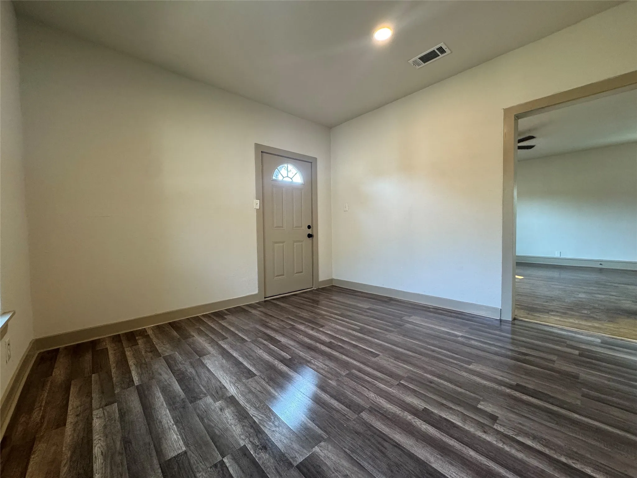Wood-finish flooring throughout, featuring a neutral color palette