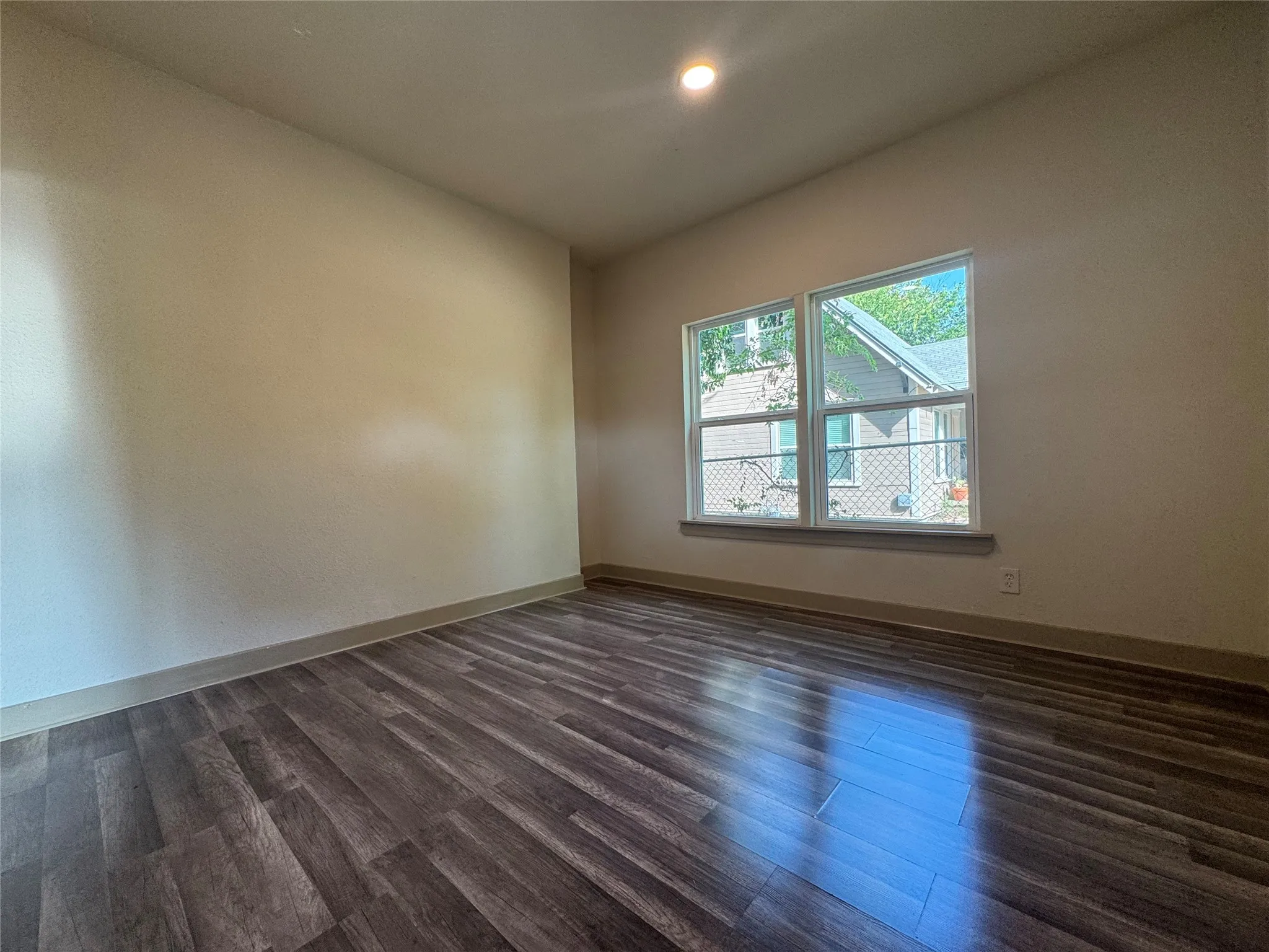 Recessed lighting, wood-finish flooring, and a pair of double-pane windows