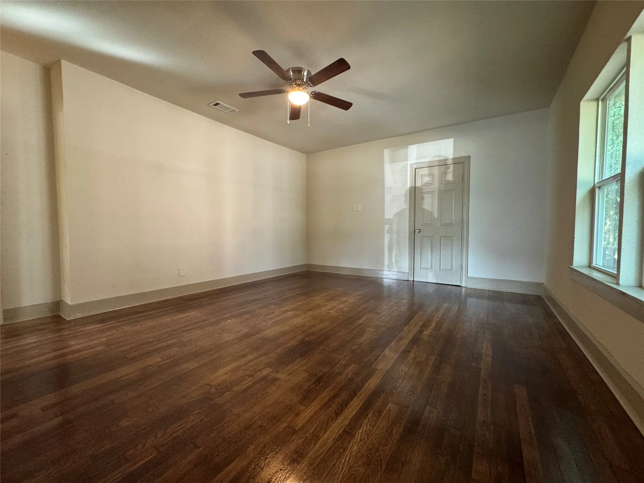 Hardwood flooring and ceiling fan light fixture