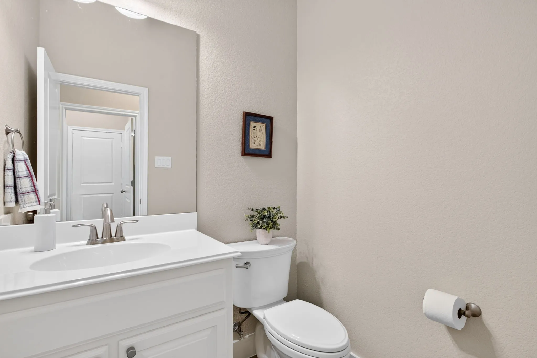 Convenient half bathroom located off foyer