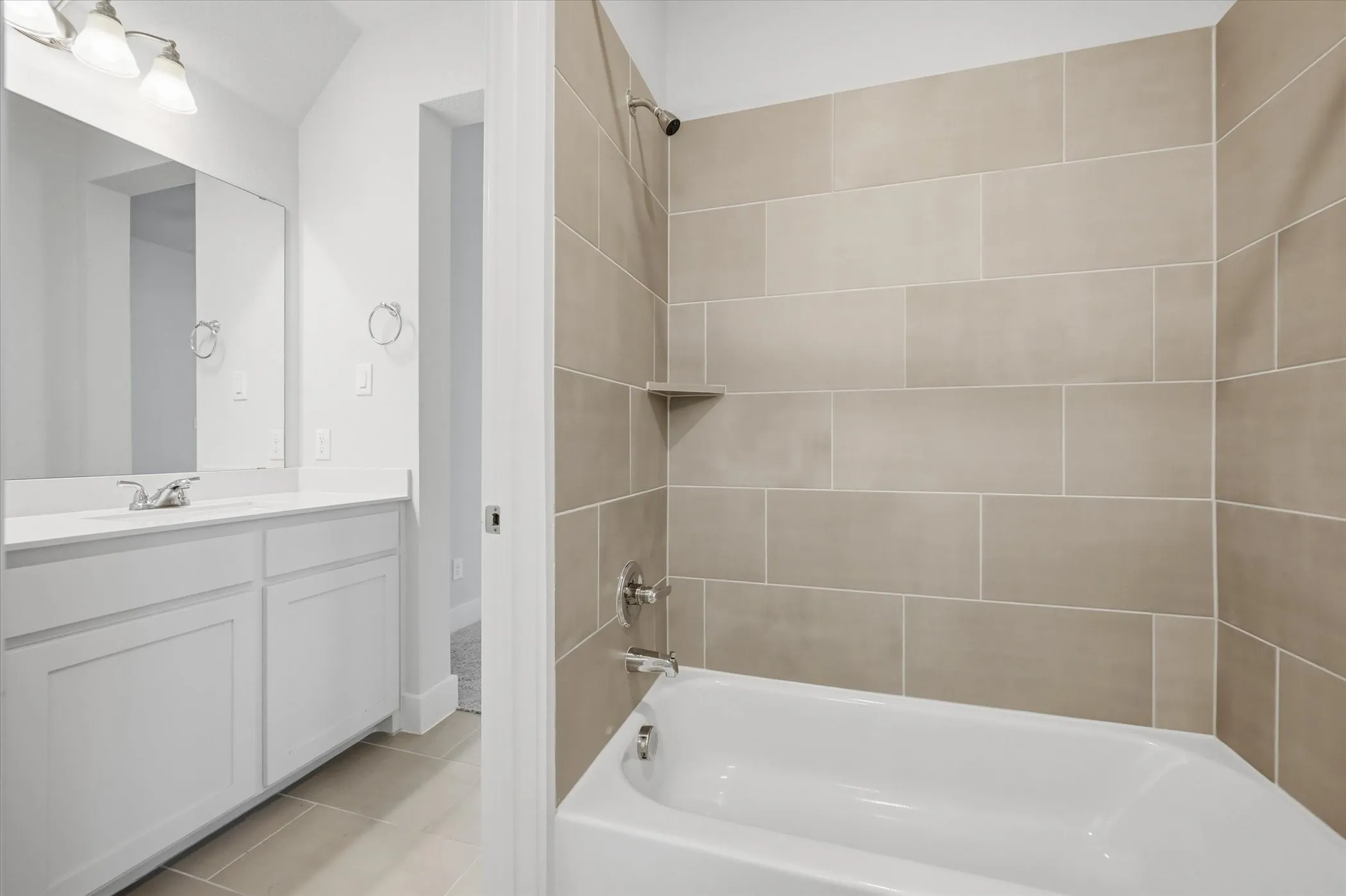 Bathroom featuring a white vanity with an integrated sink, polished chrome faucet, rectangular mirror, and an overhead light fixture