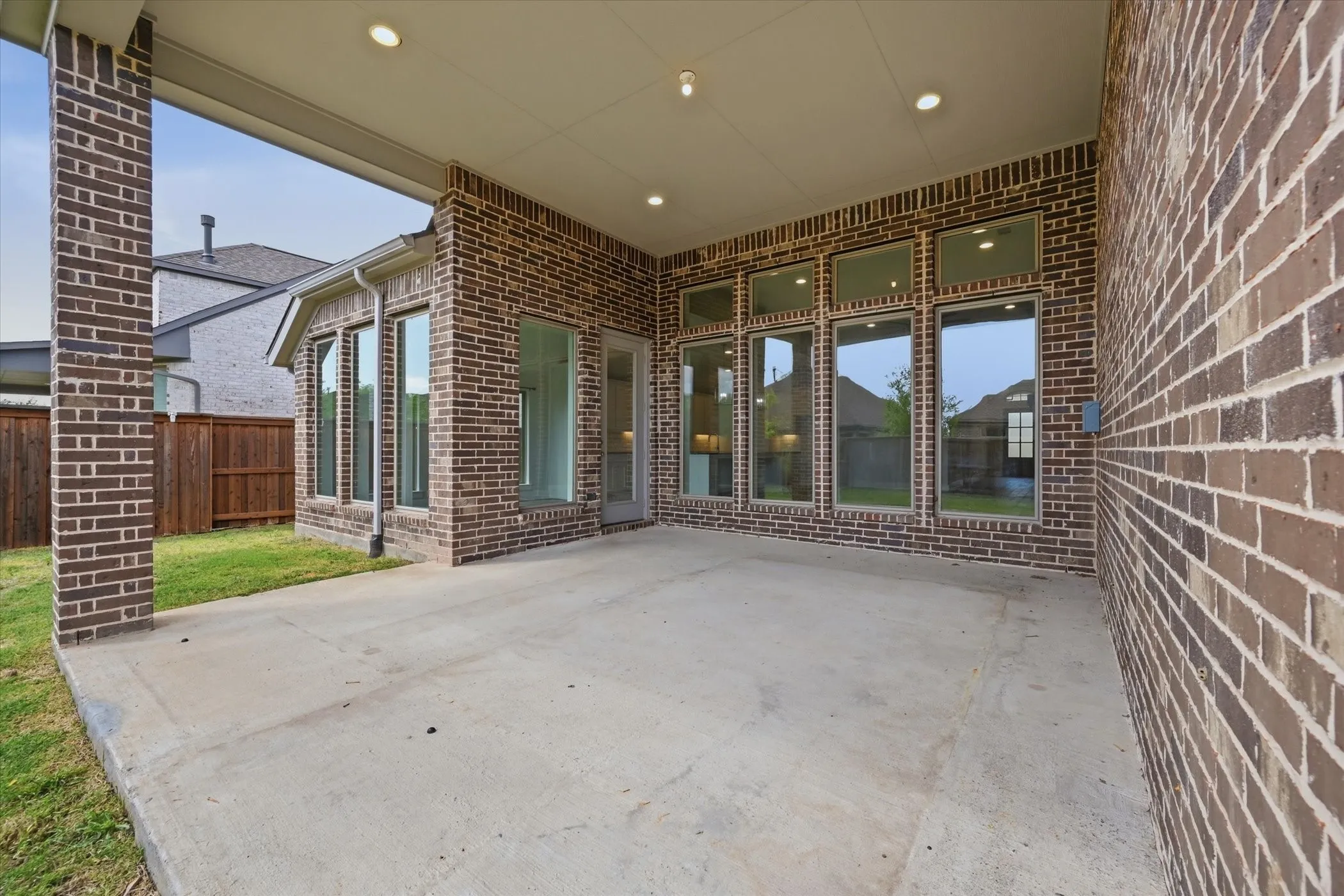 Covered concrete patio featuring recessed lighting