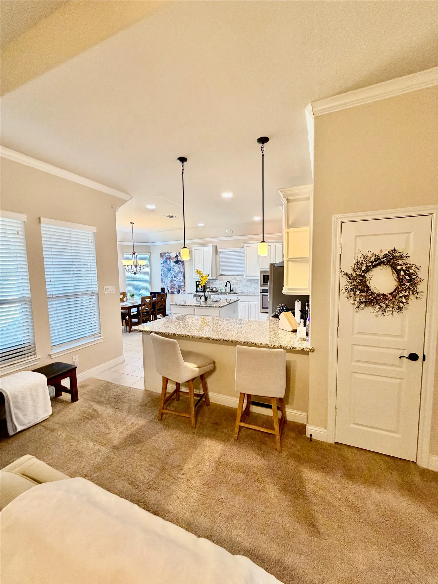 Kitchen with granite countertop breakfast bar, recessed lighting, and dual pendant fixtures