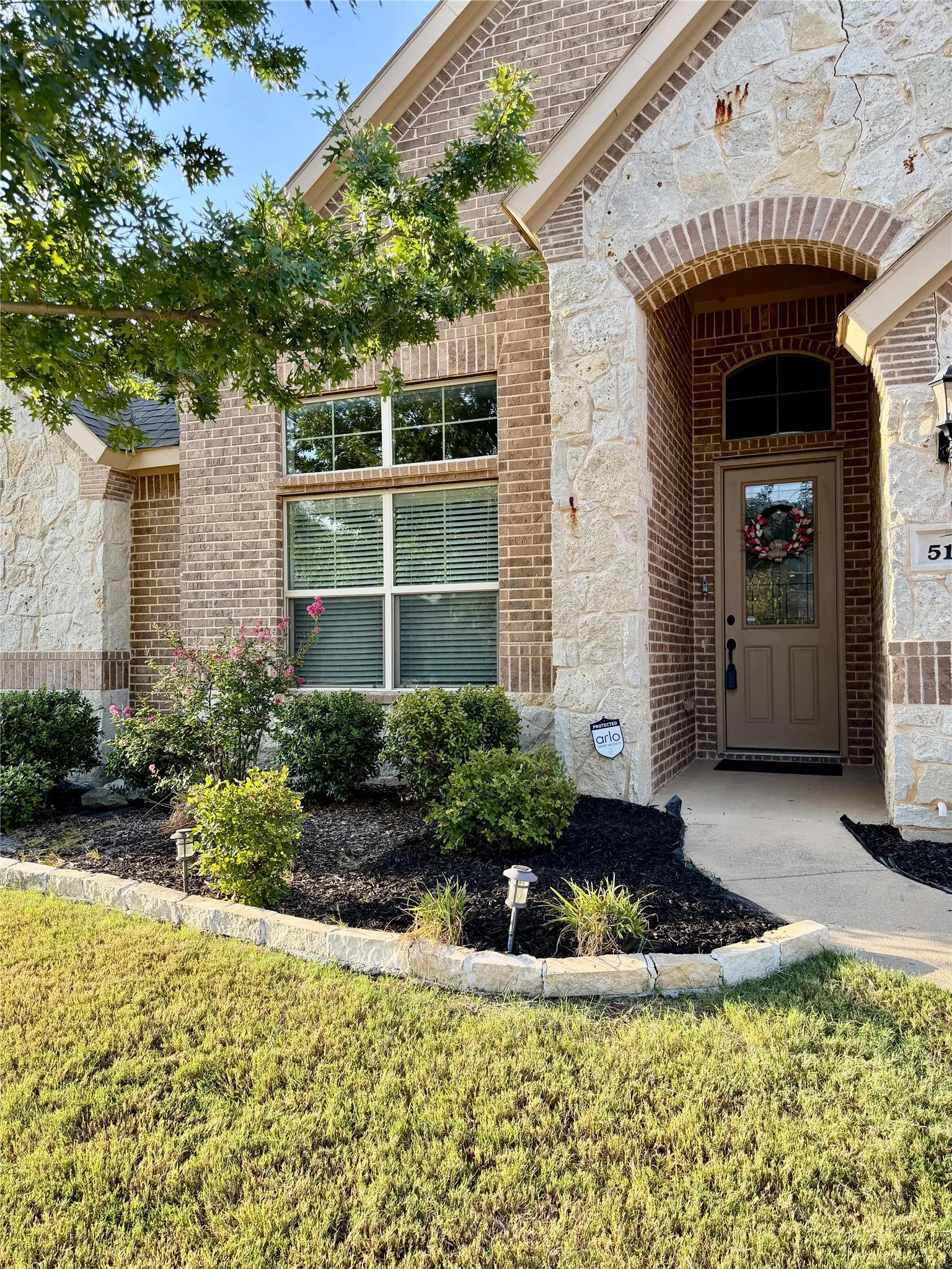 Brick and stone exterior with an arched entryway
