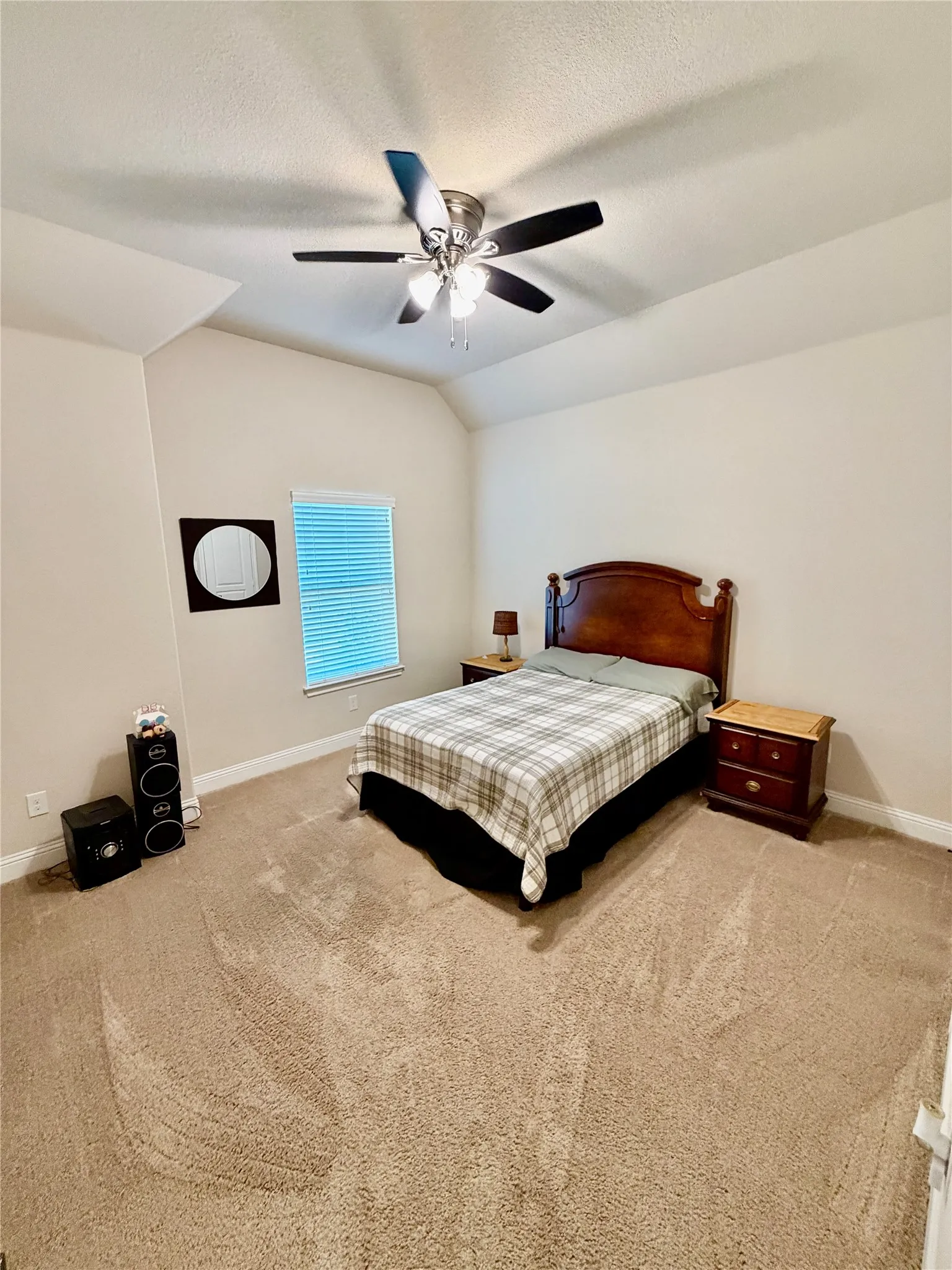 Recessed ceiling, ceiling fan with integrated lighting, window with blinds, light-toned wall paint, neutral-toned carpet