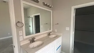 Dual vanity with undermount sinks, framed mirror, and chrome fixtures