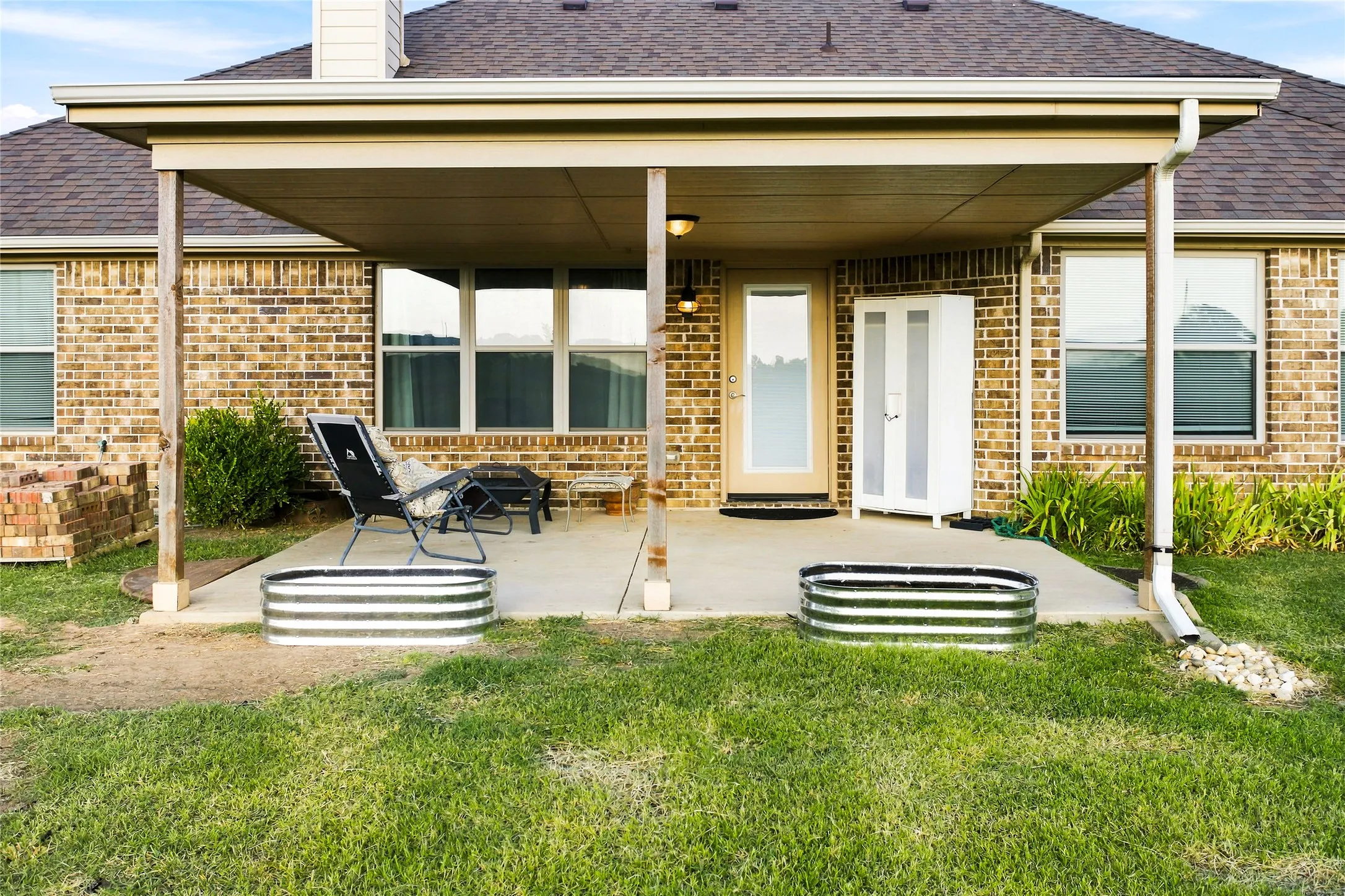 Made for relaxing in the morning or grilling burgers in the evening, this is a nice open covered space with a view of the big back yard.
