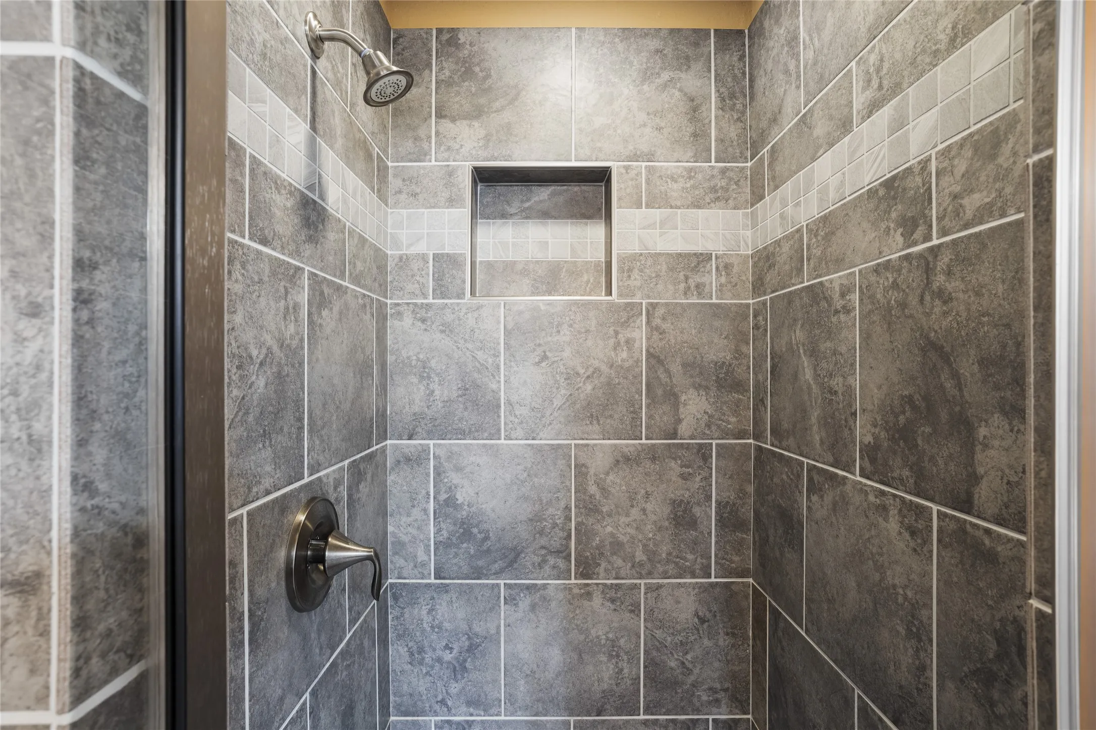 A tiled shower serves the secondary bedrooms.
