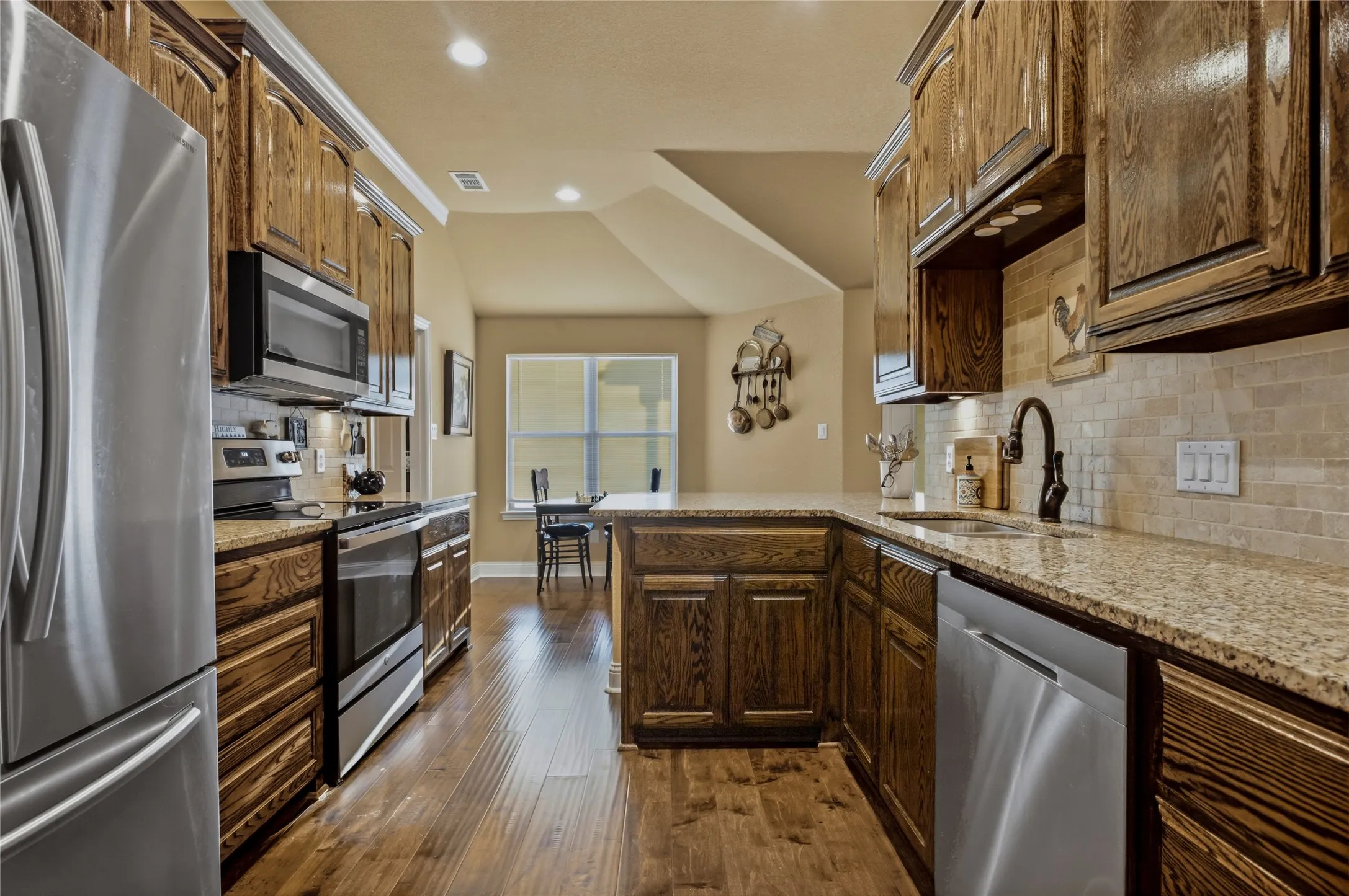 This kitchen spans about 2/3 of the width of the home.  It's open on either end from a formal dining room to an eat-in kitchen.  In between, you will find this like-new kitchen ready for you to prepare your favorite meals.