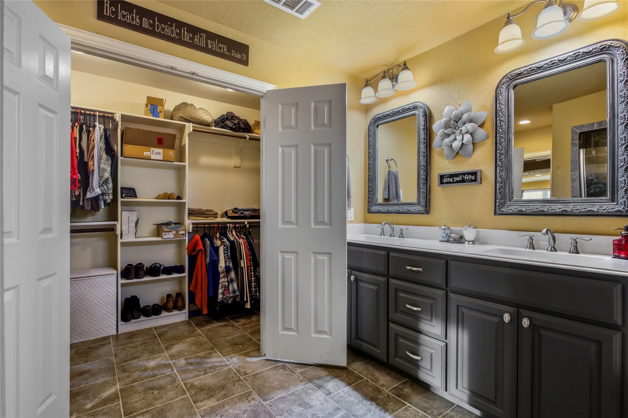 A large primary bedroom closet is located in this large bathroom.