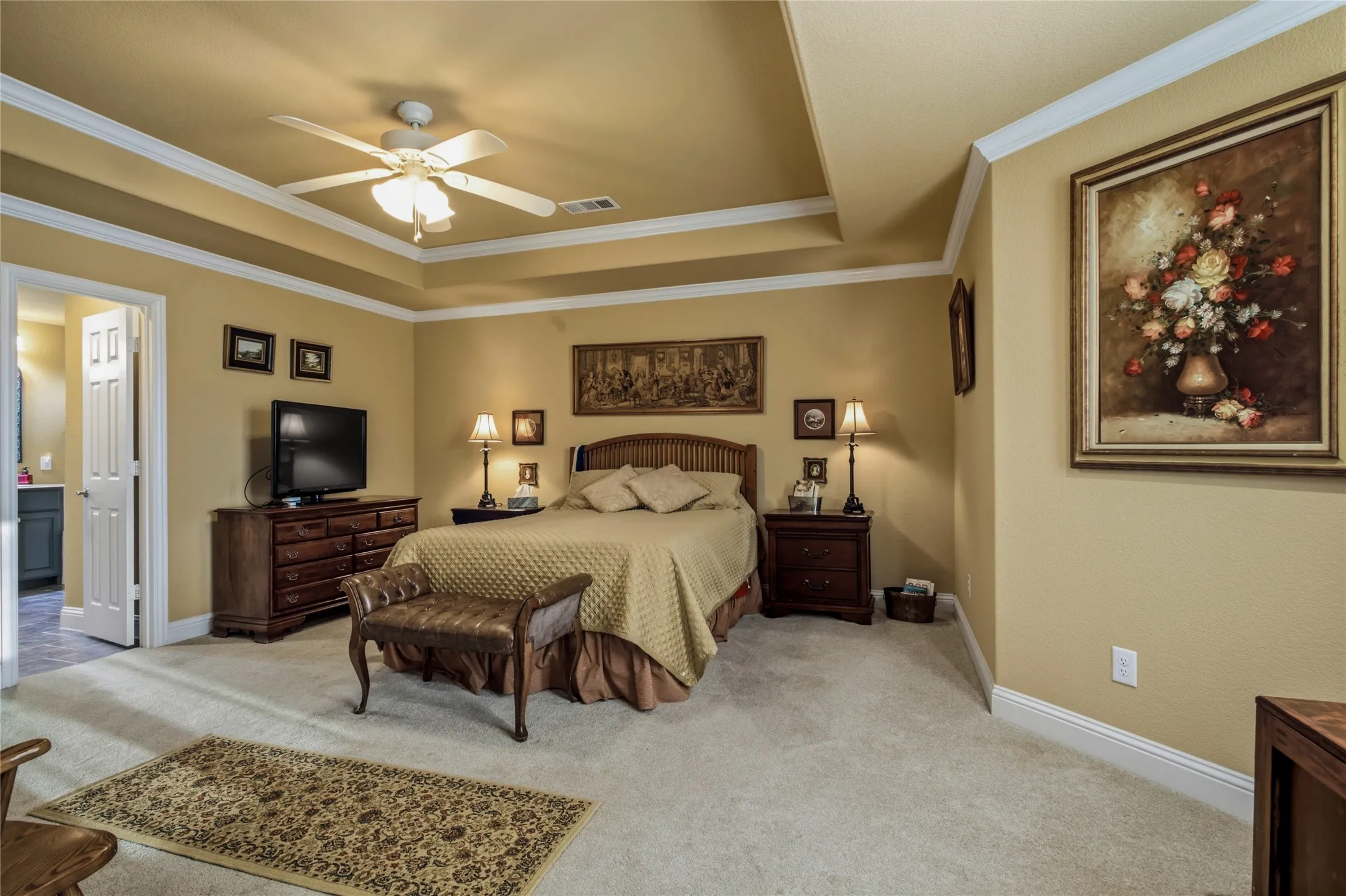 Spacious in square footage and a beautiful ceiling and trim style open this room up!  Plenty of space for the bed, but there are area on the right and the left that give you even more room for seating areas and an office.