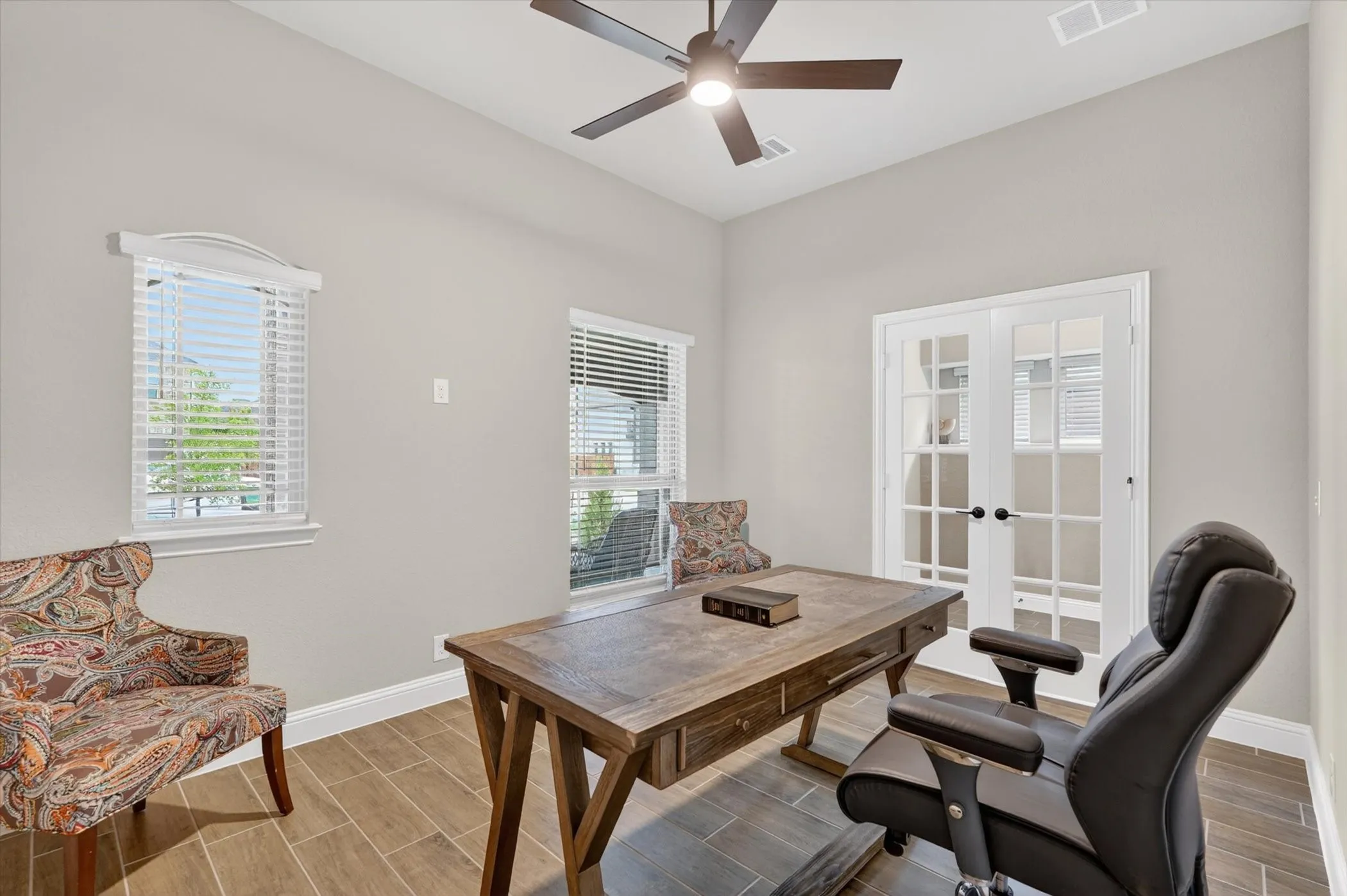Wood-finish flooring, recessed lighting, and a ceiling fan with integrated lighting