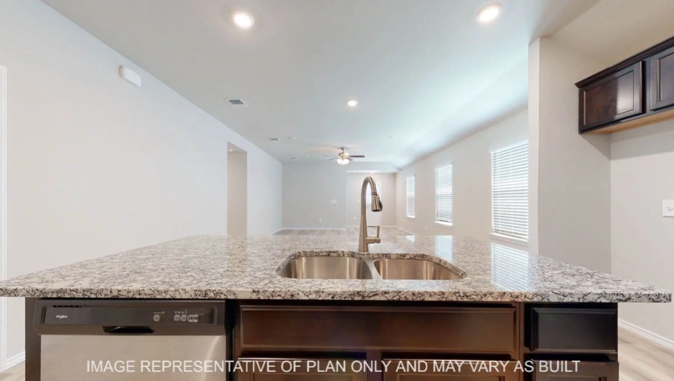 Kitchen island with a double basin stainless steel sink, a chrome gooseneck faucet, and integrated dishwasher