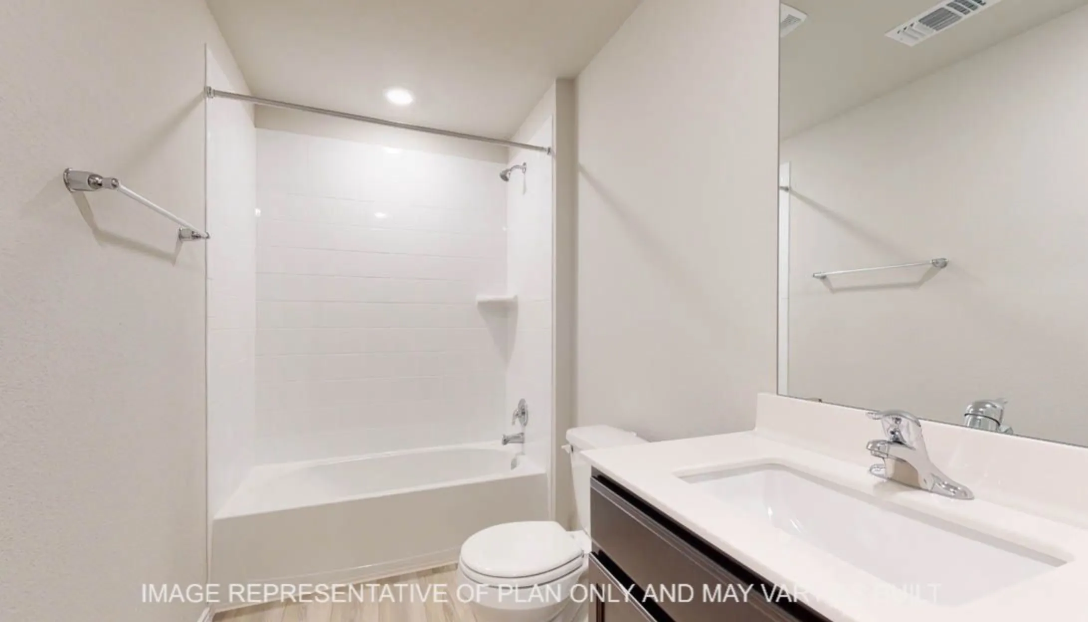 Tub/shower combination with white subway tile surround, dark wood-finish vanity with white countertop, integrated rectangular sink, and wall-mounted mirror