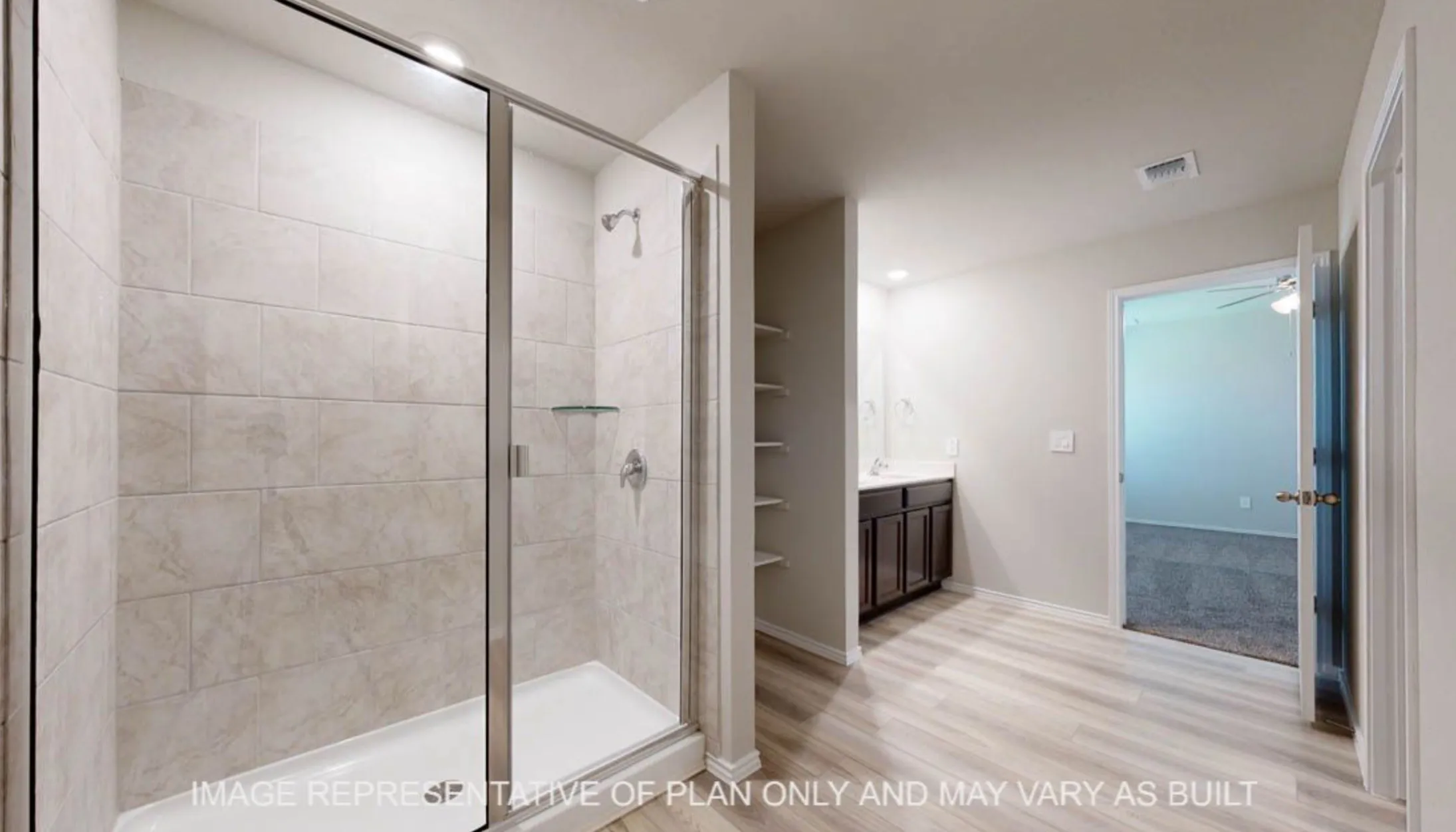 Walk-in shower with glass enclosure and tiled walls, wood-finish flooring, built-in shelving, and a vanity with dark wood-finish cabinetry