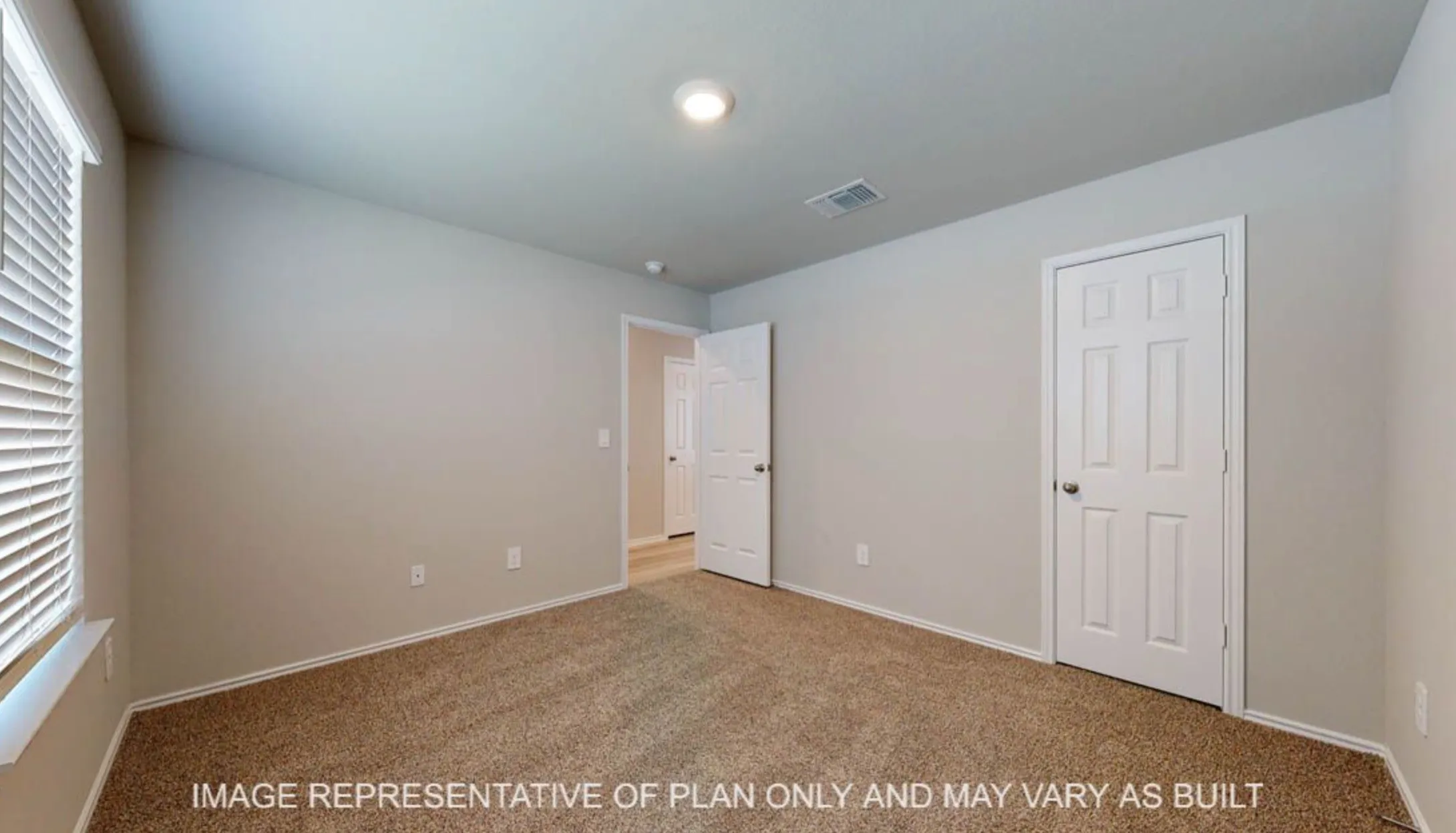 Recessed ceiling light, neutral wall color, carpeted flooring, white paneled doors, and window with horizontal blinds