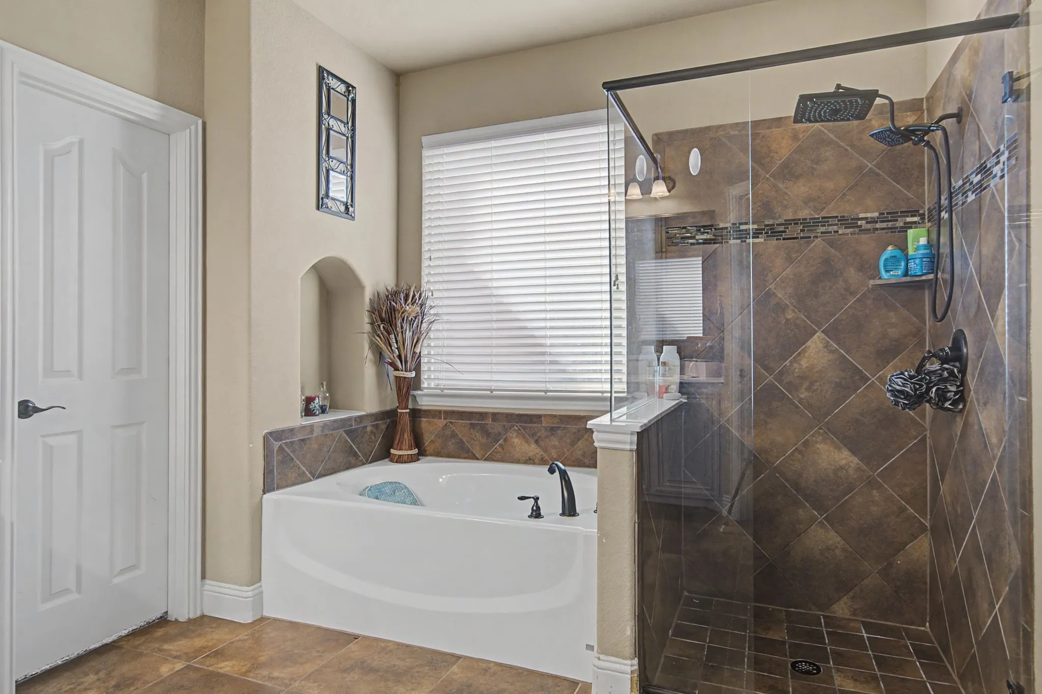 Primary bathroom with a separate tub and shower.